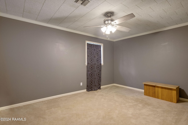 unfurnished room with ornamental molding, light carpet, and ceiling fan