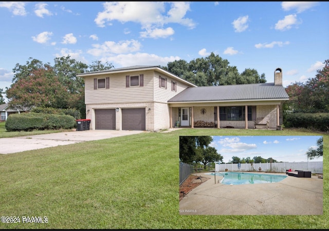 view of front of house featuring a fenced in pool, a front lawn, and a garage