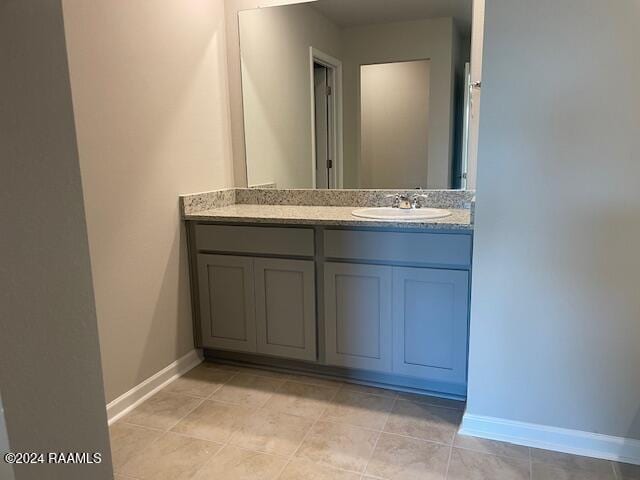 bathroom featuring vanity, tile patterned floors, and baseboards