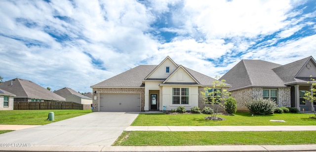 view of front of home with a front yard and a garage