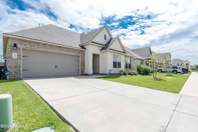 view of front of home with a garage and a front lawn