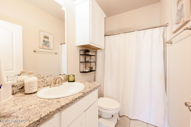 bathroom with a shower with curtain, tile patterned flooring, toilet, and vanity