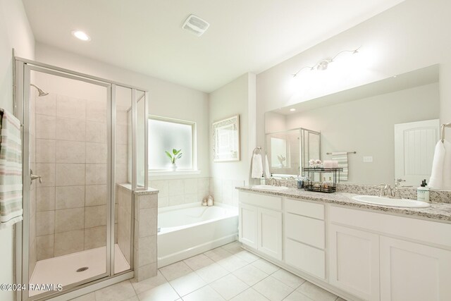 bathroom with tile patterned floors, independent shower and bath, and vanity