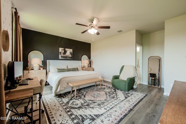 bedroom with wood-type flooring and ceiling fan