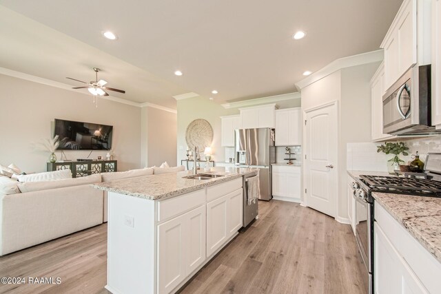 kitchen featuring white cabinets, appliances with stainless steel finishes, sink, an island with sink, and ceiling fan