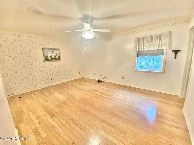 unfurnished room with ceiling fan and light hardwood / wood-style flooring