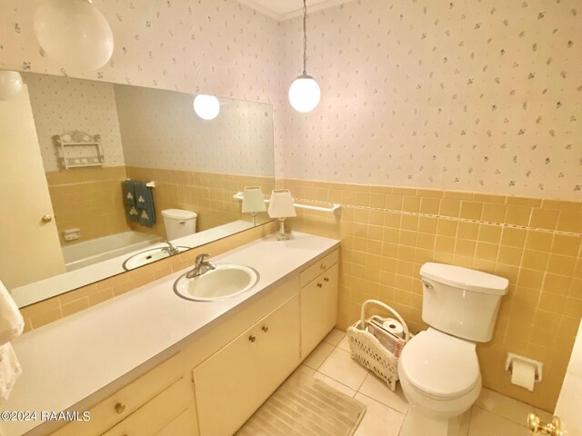 bathroom featuring vanity, tile walls, toilet, and tile patterned floors