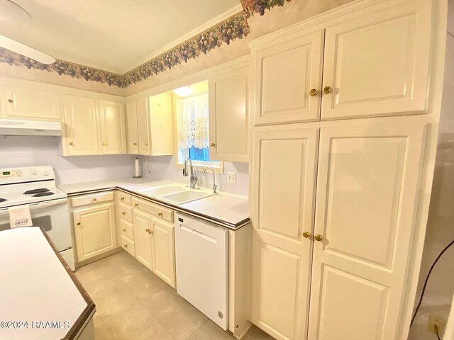 kitchen featuring white appliances, white cabinetry, and sink