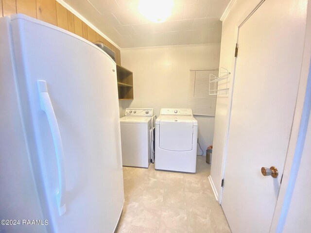 laundry room featuring wood walls and washer and dryer