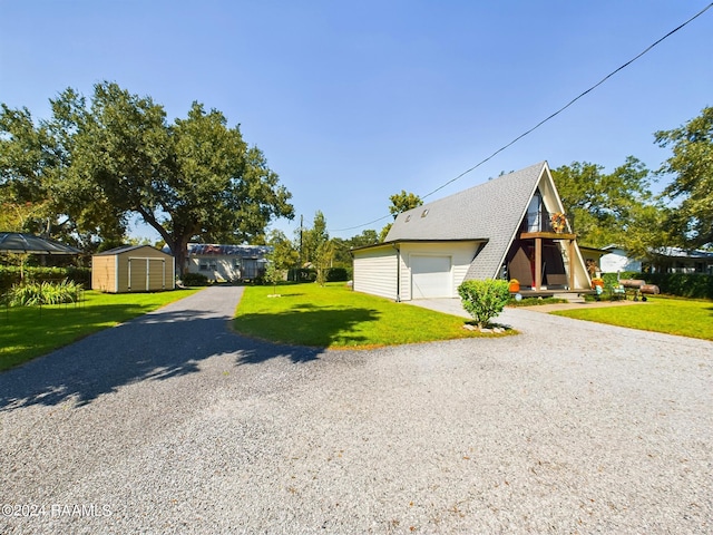 view of front of home with a garage, a storage unit, and a front lawn