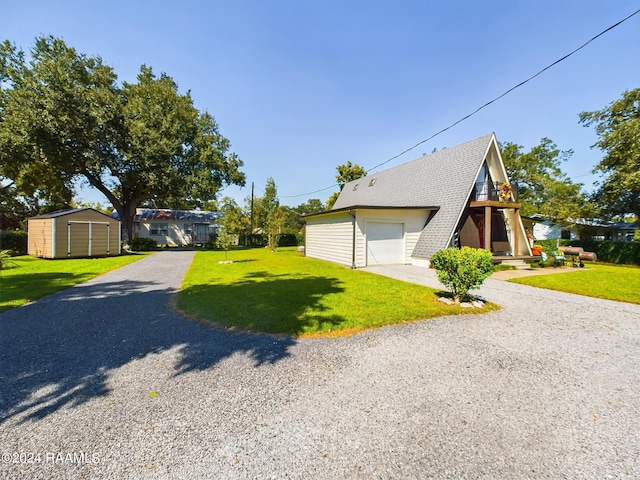 view of front of home with a garage, a shed, and a front yard