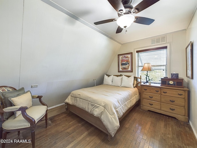 bedroom with ceiling fan, vaulted ceiling, and dark hardwood / wood-style flooring