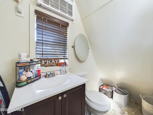 bathroom with vanity, toilet, and an AC wall unit