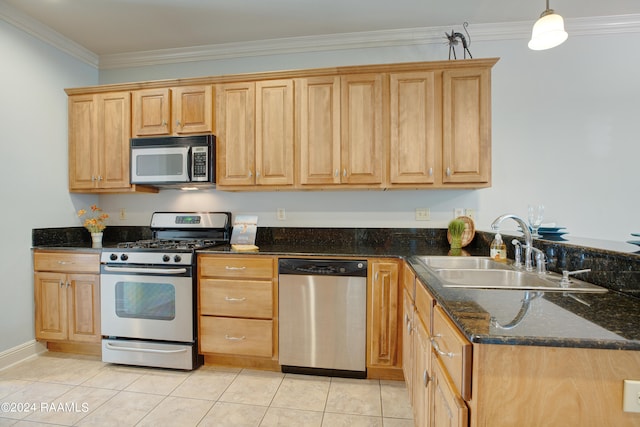 kitchen with dark stone countertops, light tile patterned floors, stainless steel appliances, sink, and ornamental molding