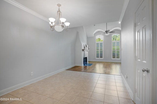 spare room with ceiling fan with notable chandelier, light wood-type flooring, and ornamental molding