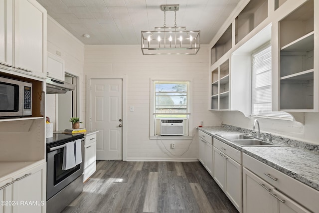 kitchen featuring open shelves, a sink, light countertops, dark wood-type flooring, and appliances with stainless steel finishes