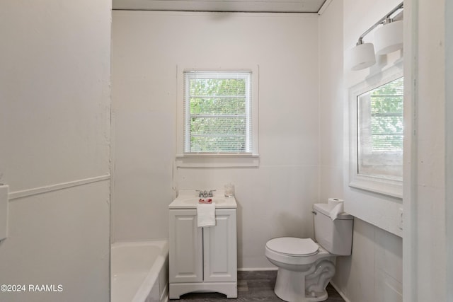 bathroom with a tub, toilet, and a sink