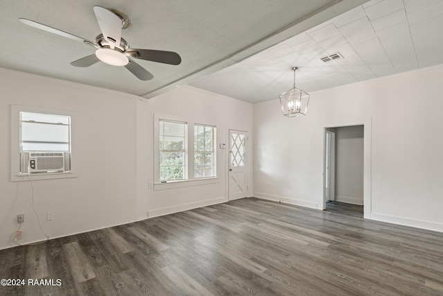 unfurnished room with crown molding, wood finished floors, visible vents, and baseboards