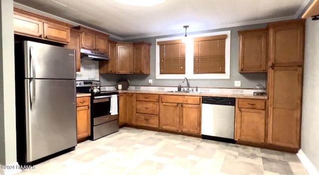 kitchen featuring stainless steel appliances, ornamental molding, decorative light fixtures, and sink