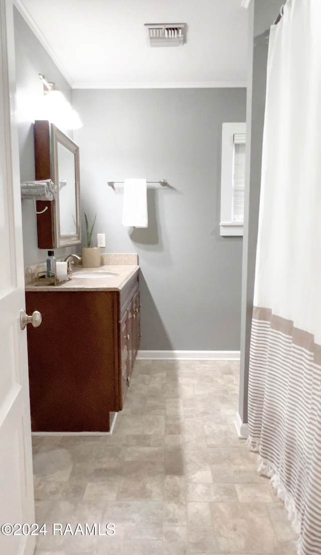 bathroom with crown molding and vanity