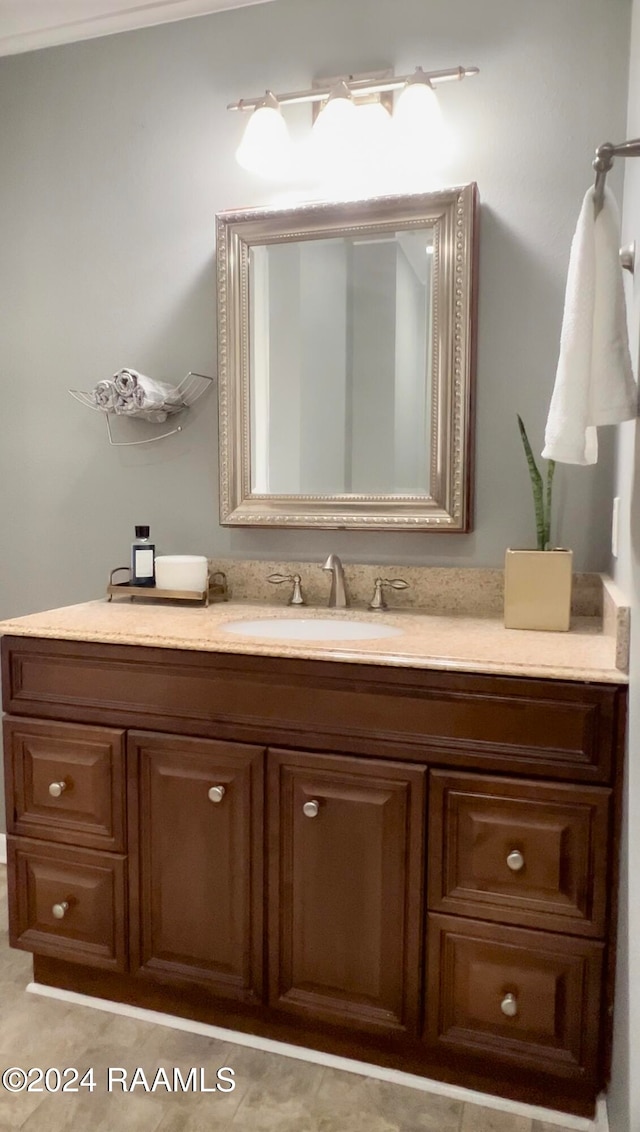 bathroom with vanity, crown molding, and tile patterned floors