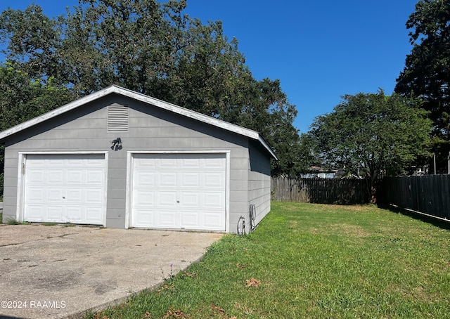 garage featuring a lawn