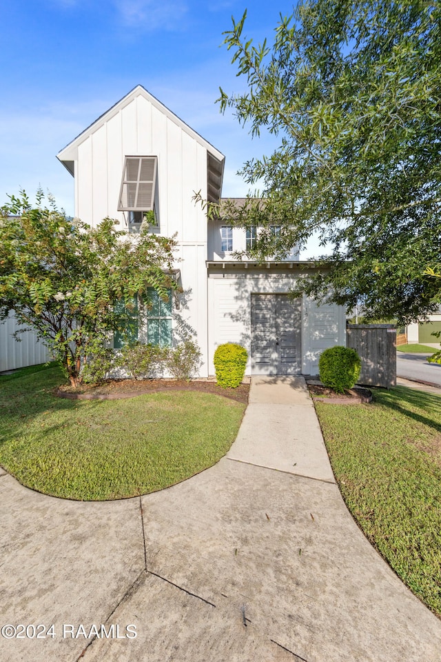 view of front of property with a garage and a front yard