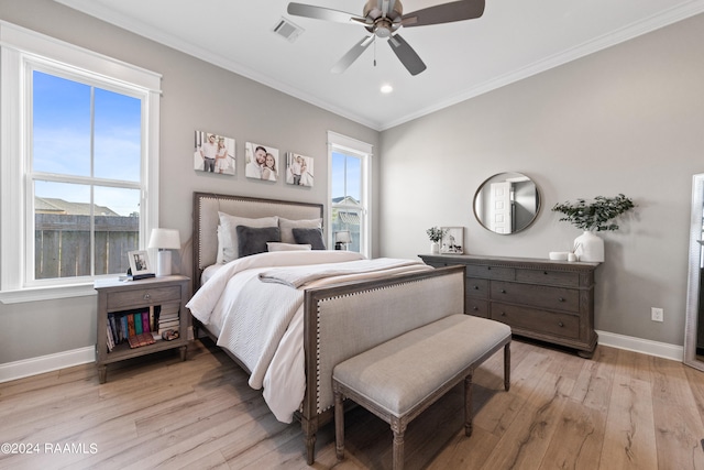 bedroom with ornamental molding, ceiling fan, and light hardwood / wood-style flooring