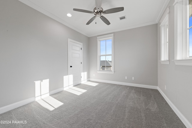 carpeted spare room featuring crown molding and ceiling fan