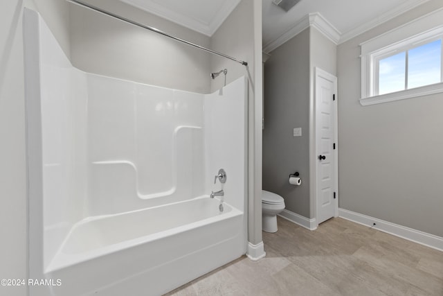 bathroom with crown molding, shower / bathtub combination, and toilet