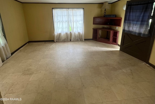 unfurnished living room with ornamental molding