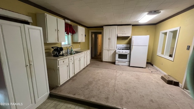 kitchen featuring white appliances, white cabinetry, light carpet, and sink