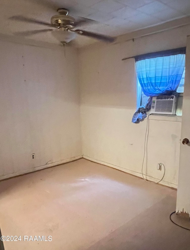 spare room with cooling unit and ceiling fan