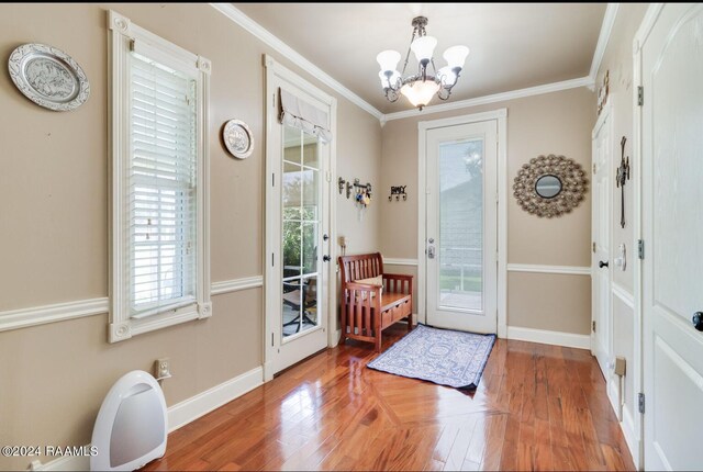 entryway featuring ornamental molding, hardwood / wood-style flooring, and a healthy amount of sunlight