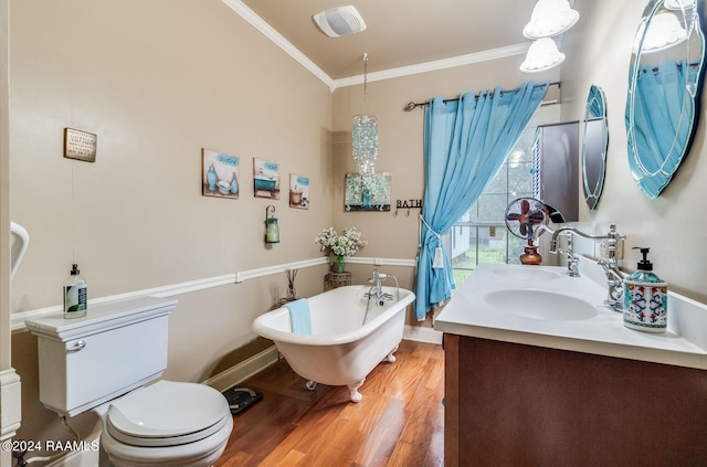 bathroom with hardwood / wood-style flooring, toilet, a tub, vanity, and ornamental molding