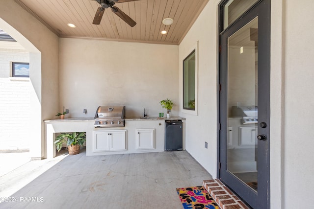 view of patio with area for grilling, ceiling fan, and sink