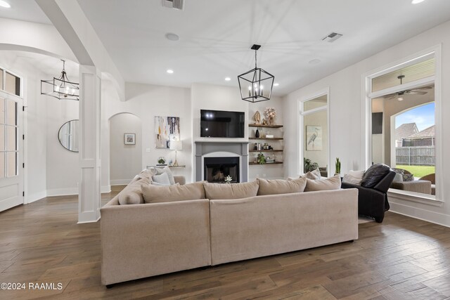 living room with a chandelier and dark hardwood / wood-style floors