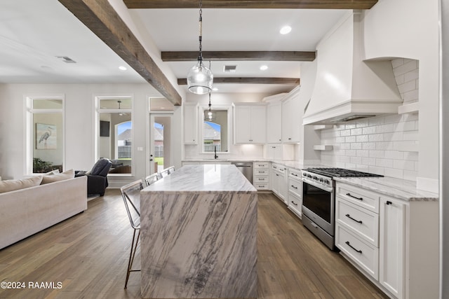 kitchen featuring appliances with stainless steel finishes, beam ceiling, dark hardwood / wood-style flooring, and white cabinets