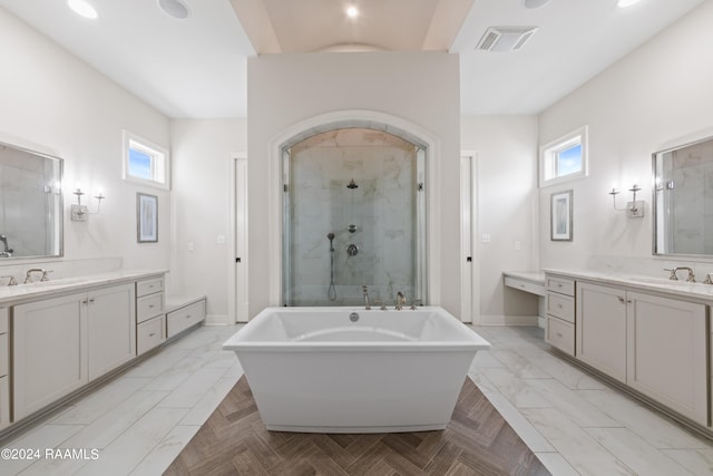 bathroom featuring shower with separate bathtub, a healthy amount of sunlight, and vanity