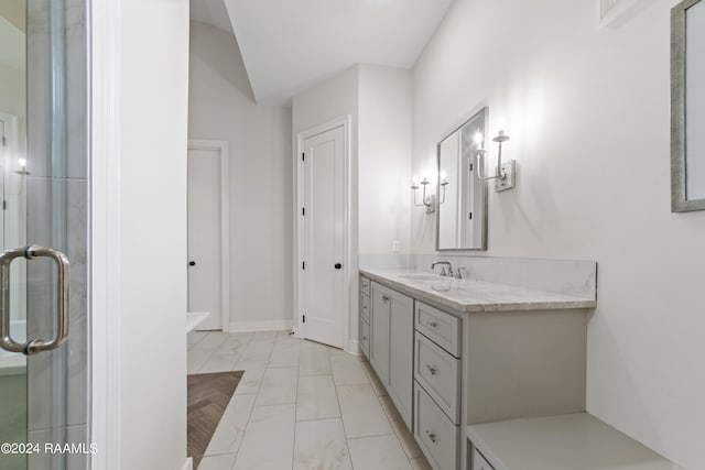 bathroom featuring walk in shower, vanity, and vaulted ceiling