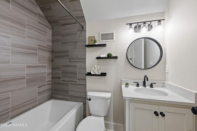 full bathroom with lofted ceiling, tiled shower / bath combo, vanity, and toilet