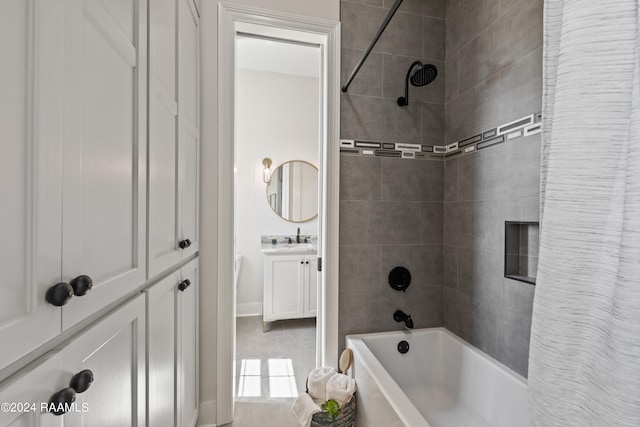 bathroom featuring shower / bath combo with shower curtain, tile patterned floors, and vanity