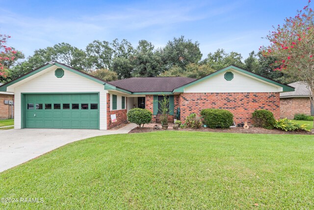 single story home featuring a garage and a front yard