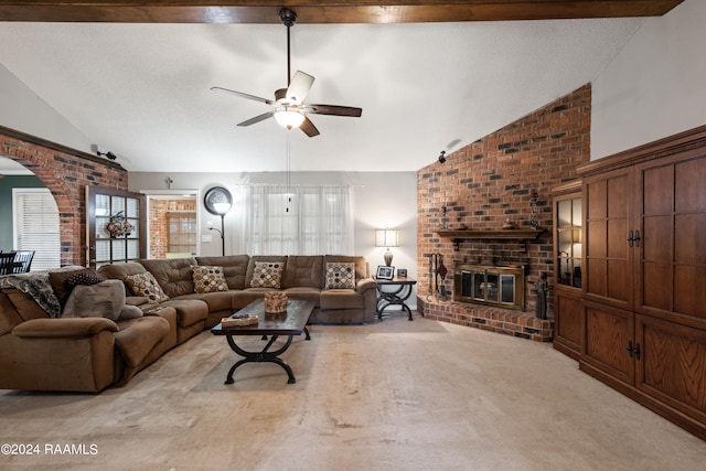 living room with ceiling fan, a wealth of natural light, beam ceiling, and a brick fireplace