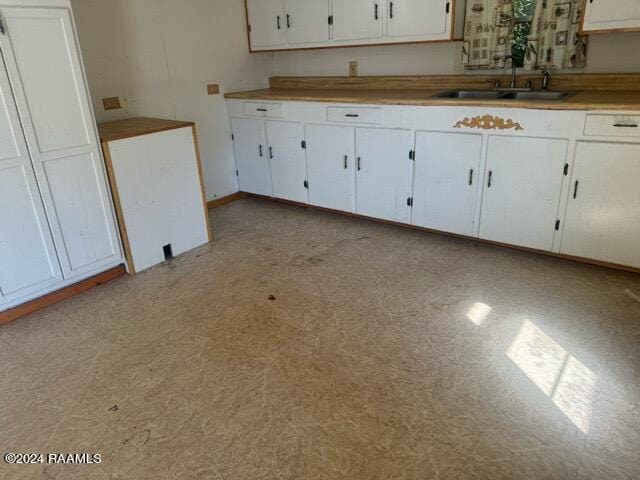 kitchen with white cabinetry and sink