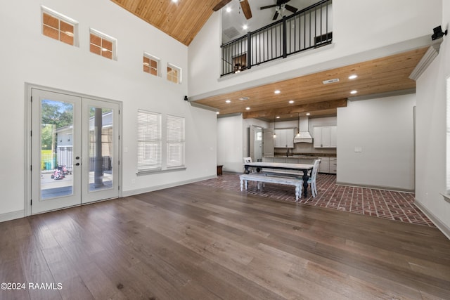 living area with french doors, dark wood-style flooring, wood ceiling, ceiling fan, and baseboards