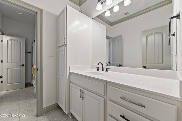 bathroom with crown molding and vanity