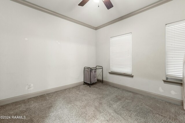 carpeted empty room with ceiling fan and ornamental molding