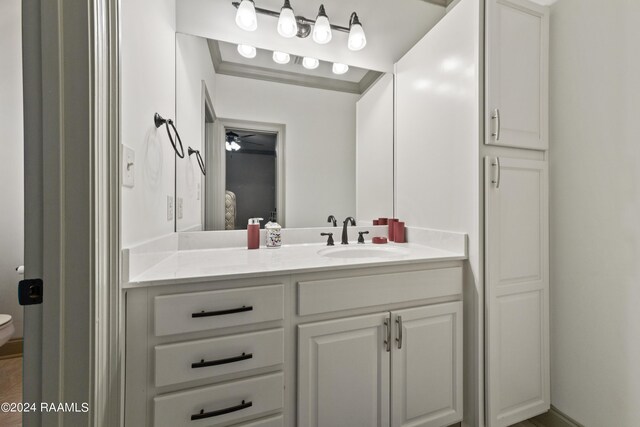 bathroom featuring ceiling fan, toilet, and vanity