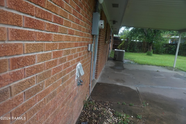 details featuring central air condition unit and brick siding